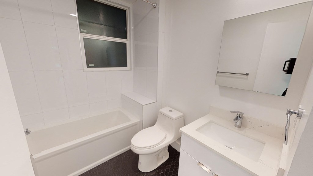 a small bathroom with a toilet and a tub