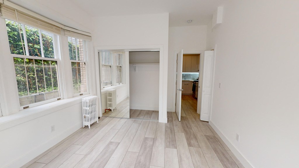 a living room with a large window and a wooden floor