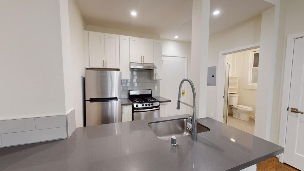 a kitchen with a stainless steel counter top and a sink