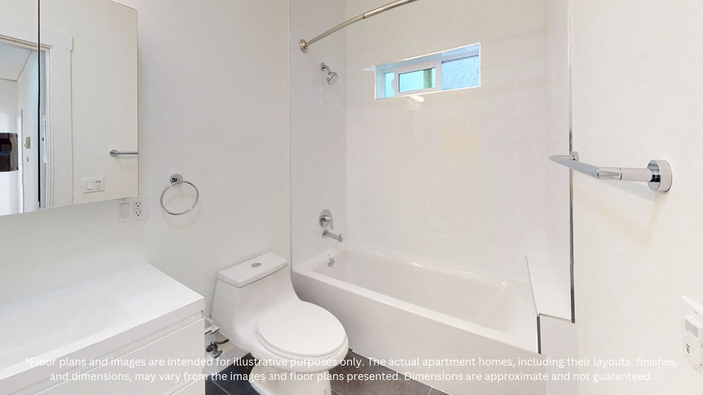 a white bathroom with a tub and a toilet