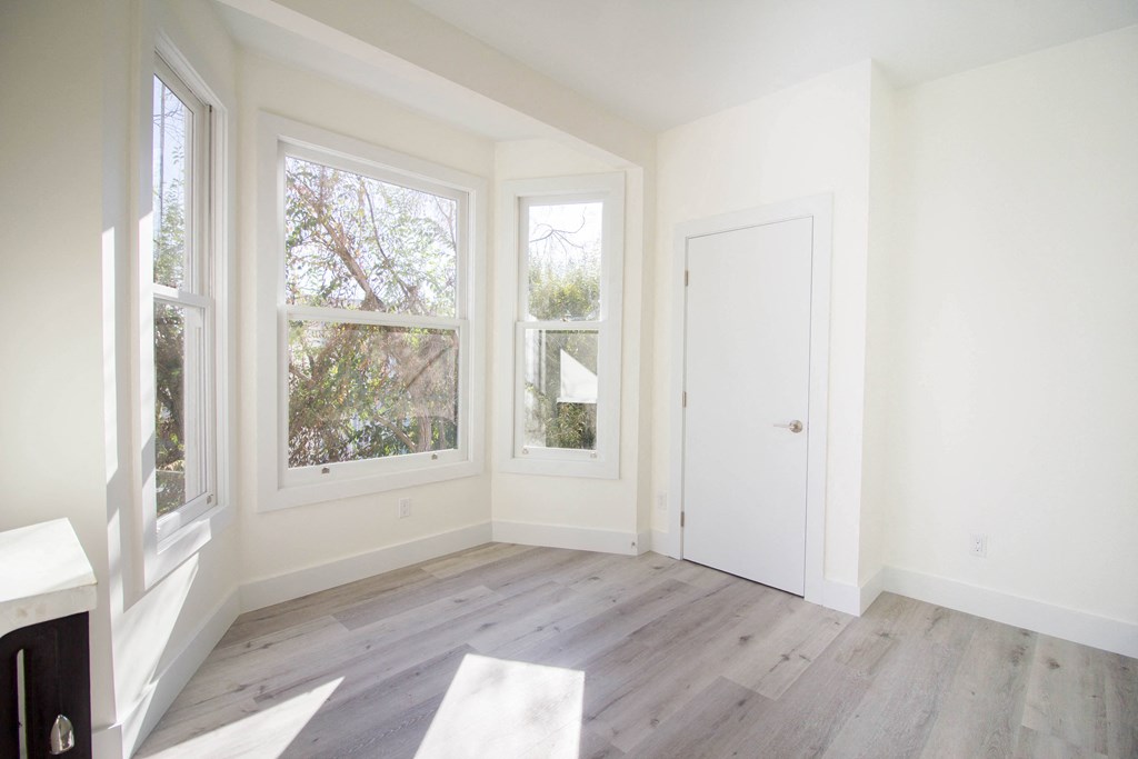 spacious bedroom with multiple windows.