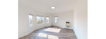 an empty living room with a bay window