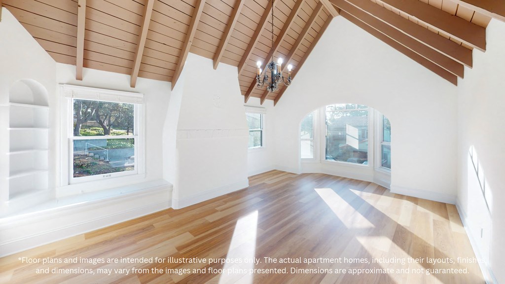 a large living room with white walls and a wooden floor