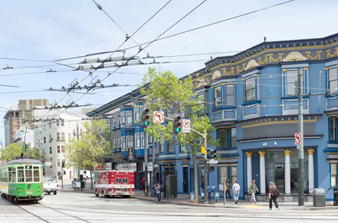 A street scene with a tram and a red vehicle.