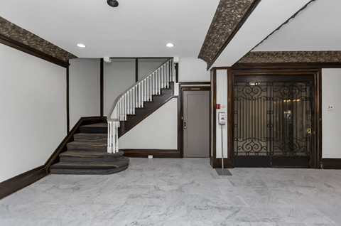 A staircase with a metal railing and a wooden handrail.