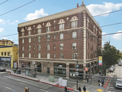 a large brick building on the corner of a city street