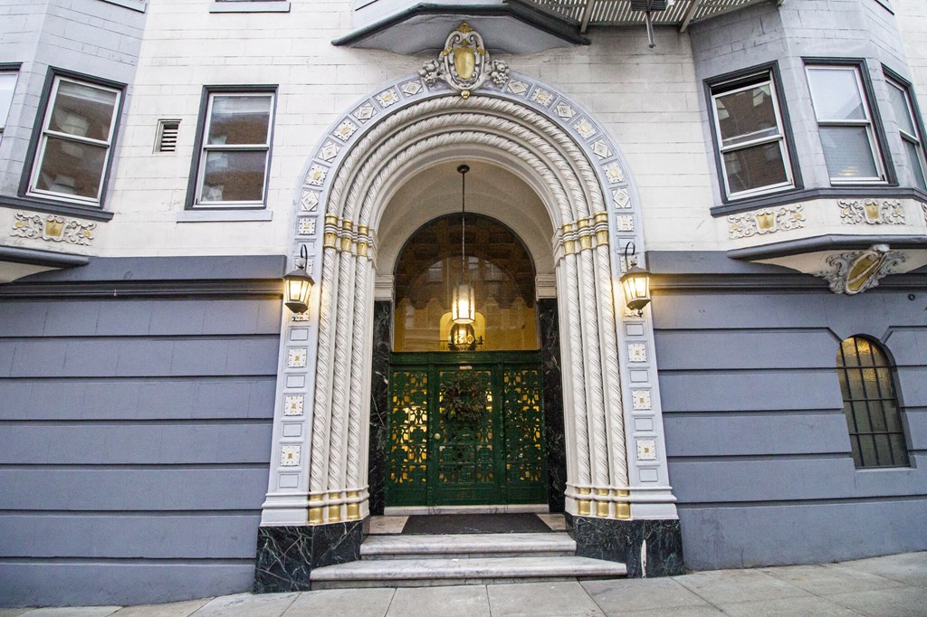 the front of a building with a green door