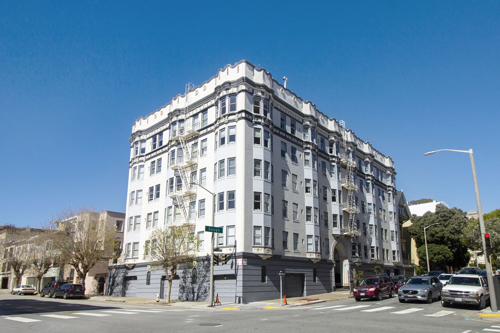 a large white building on the corner of a city street