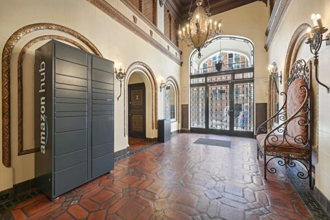 Elegant building entrance with ornate decor, Amazon Hub locker, tiled floor, wrought iron fixtures