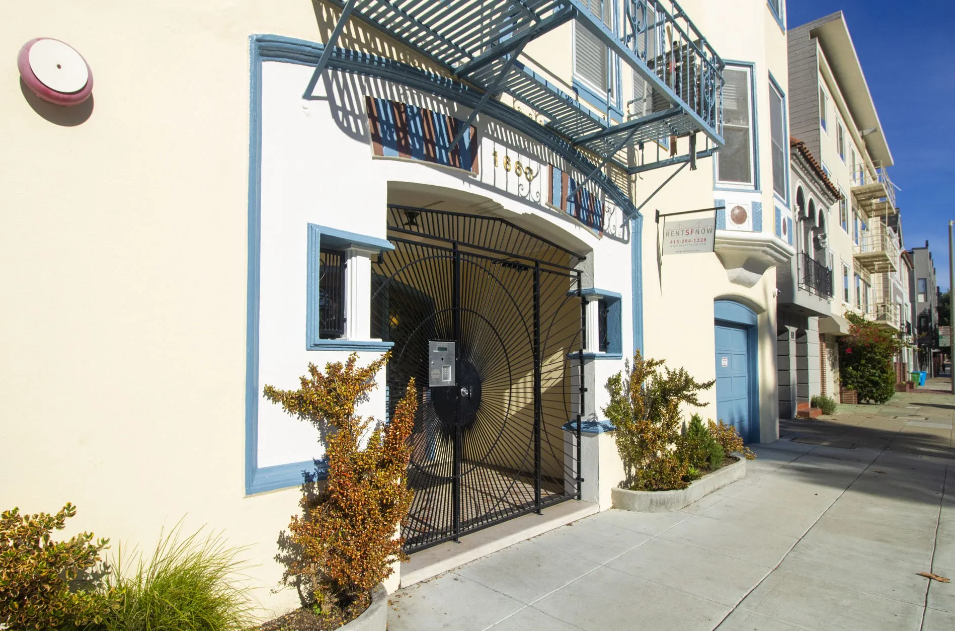 the front door of a building with a black gate