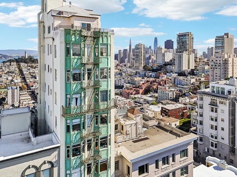 A cityscape with a green building in the foreground.
