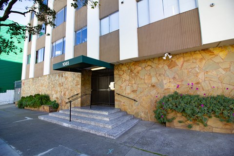 a building with a stone facade and a black door