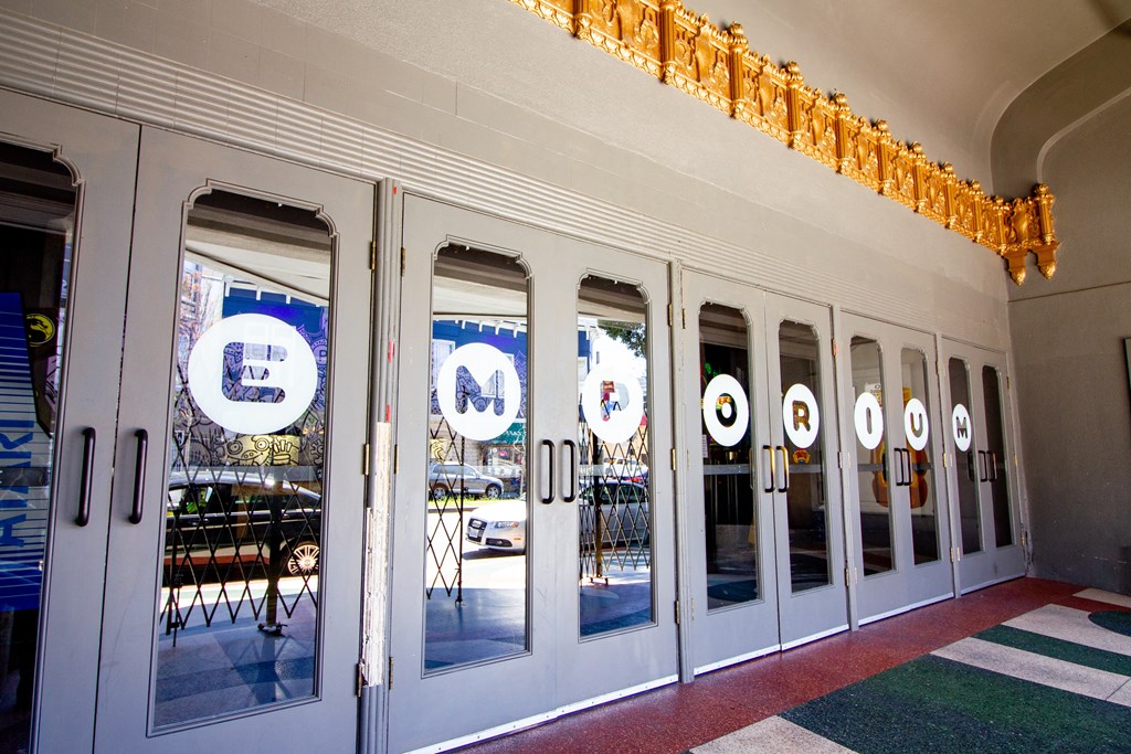 a group of doors with logos on the windows of a building