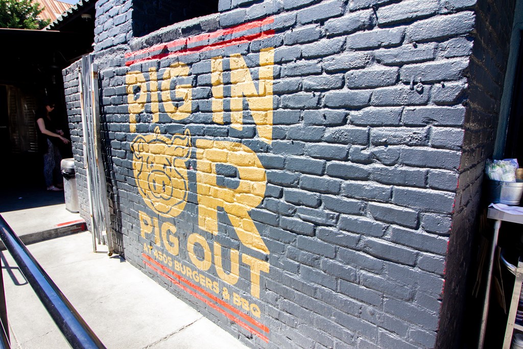a brick wall with an advertisement for rg out on it