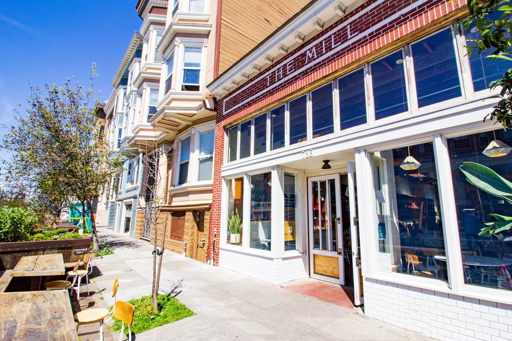 the front of a building with a sidewalk in front of it