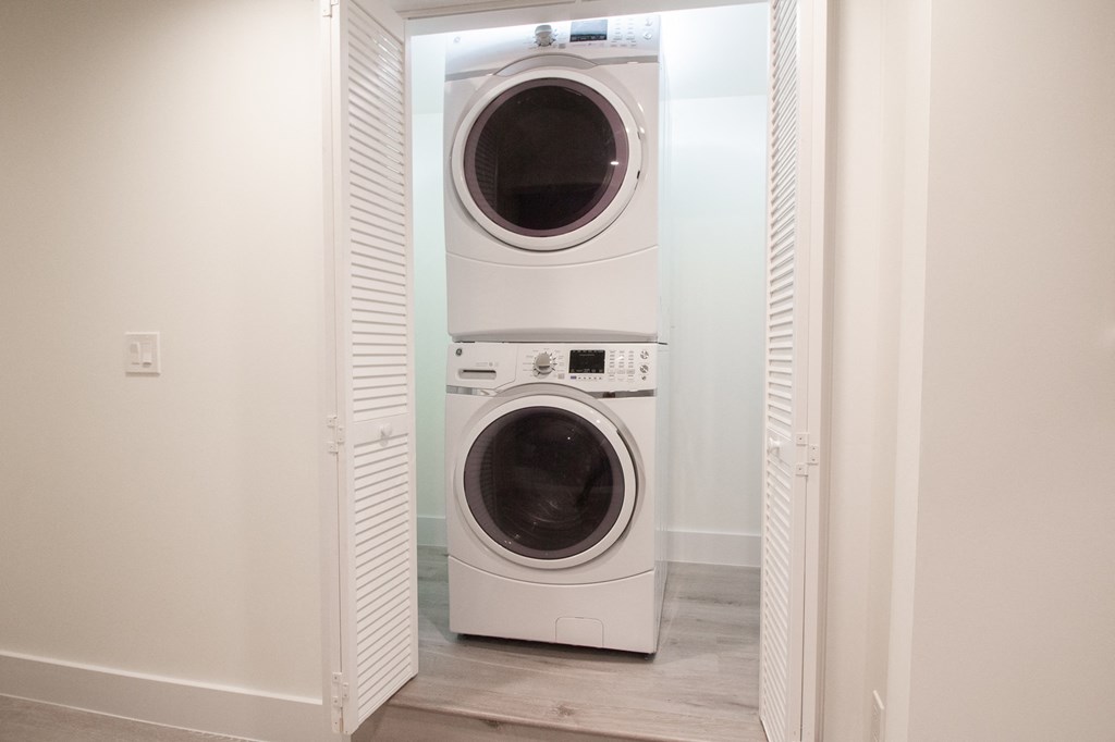 a front loading washer and dryer in a laundry room