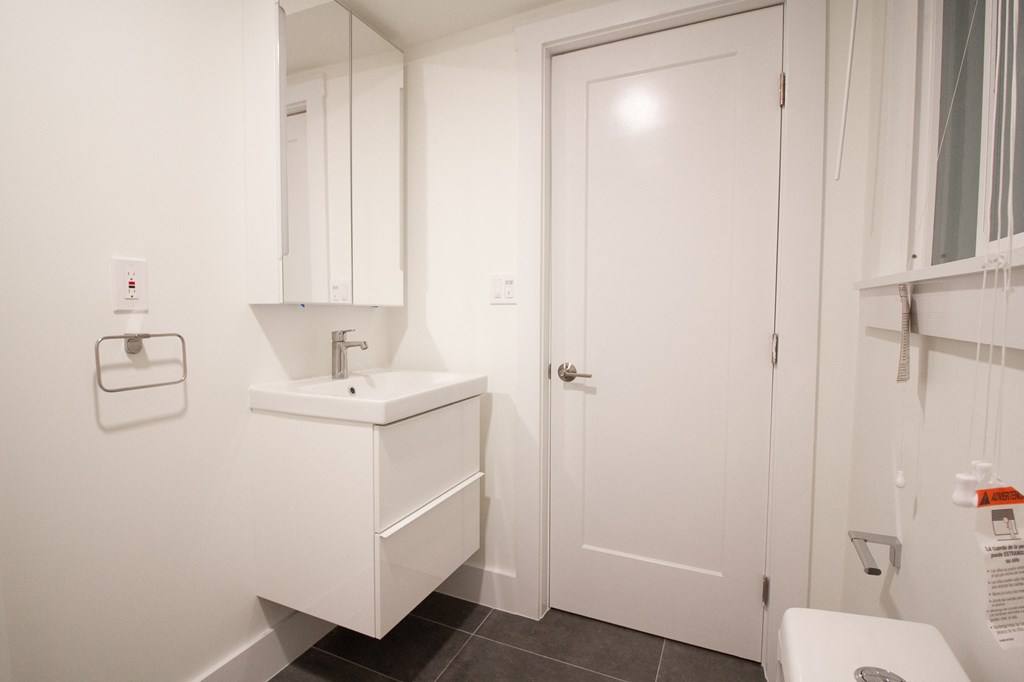 a white bathroom with a sink and a toilet