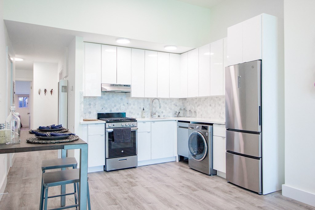 kitchen with a dining area, cabinets and upgraded appliances.