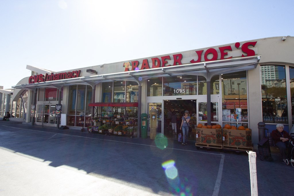 a trader joes store on the side of a street