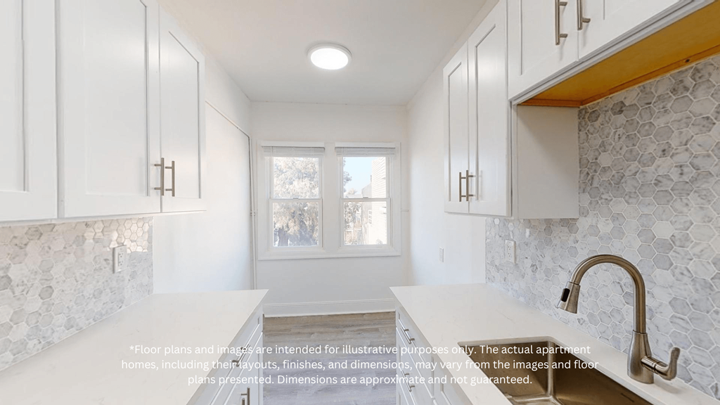 an image of a kitchen with white cabinets and a window