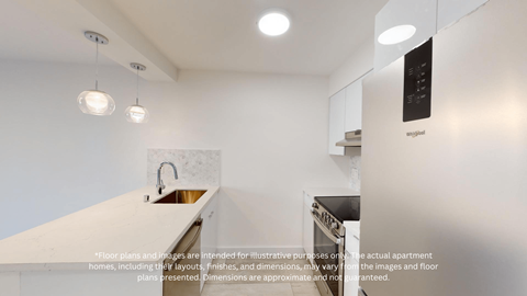 a white kitchen with white counter tops and a sink