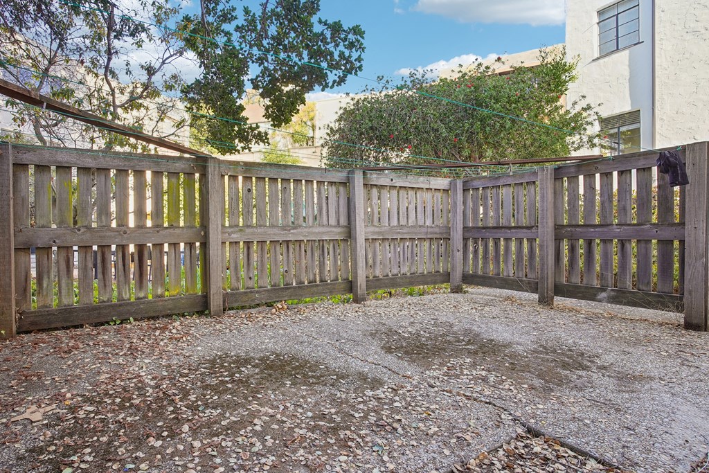 Wooden fence with a yard in front of a house