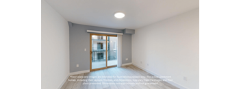 an empty room with a door to a balcony