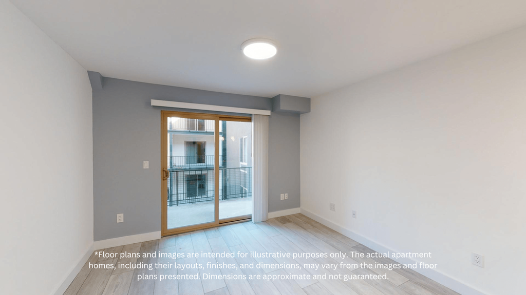 an empty room with a door to a balcony