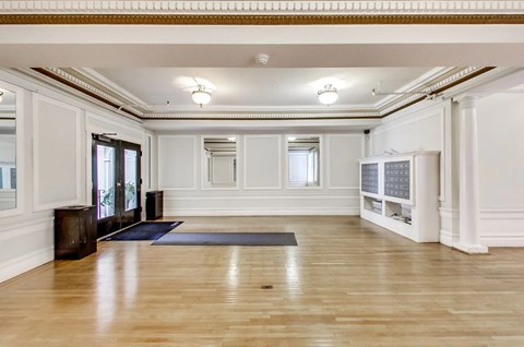 A spacious room with wooden floors and white walls.