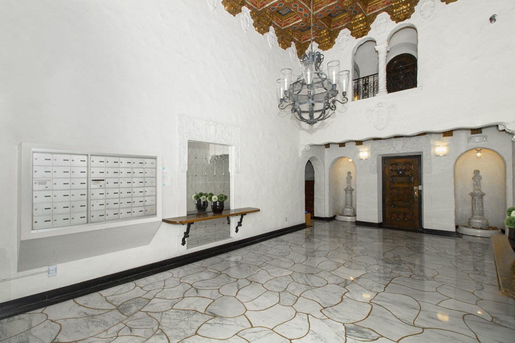 the lobby of a building with a marble floor and a chandelier