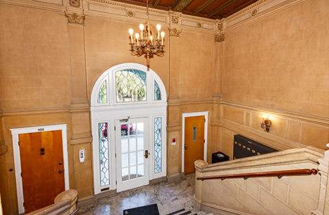 Elegant lobby with a grand staircase and a chandelier