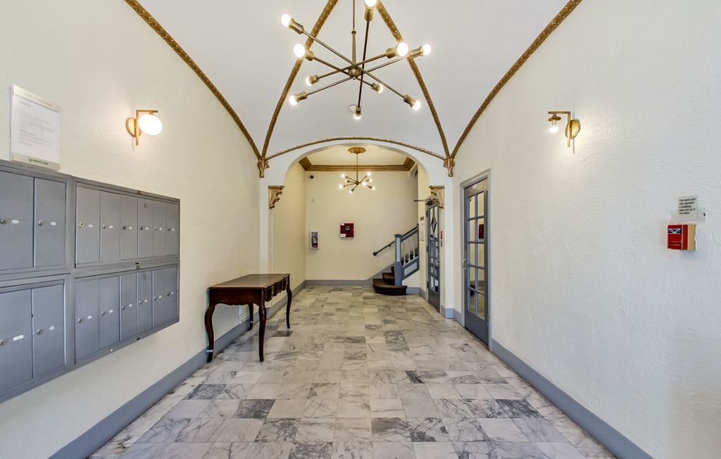 Hallway with a chandelier and mailboxes
