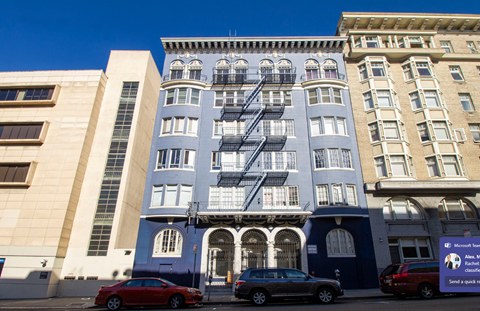 A blue building with a fire escape on the side.