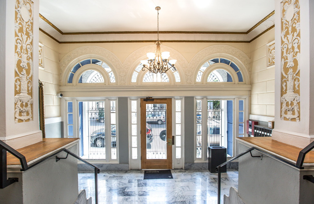 Elegant lobby with a chandelier, and Victorian-style interior design