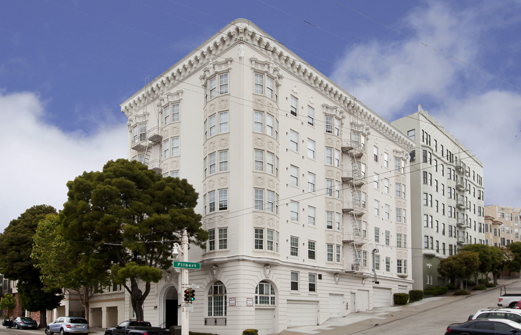 a white building on the corner of a city street