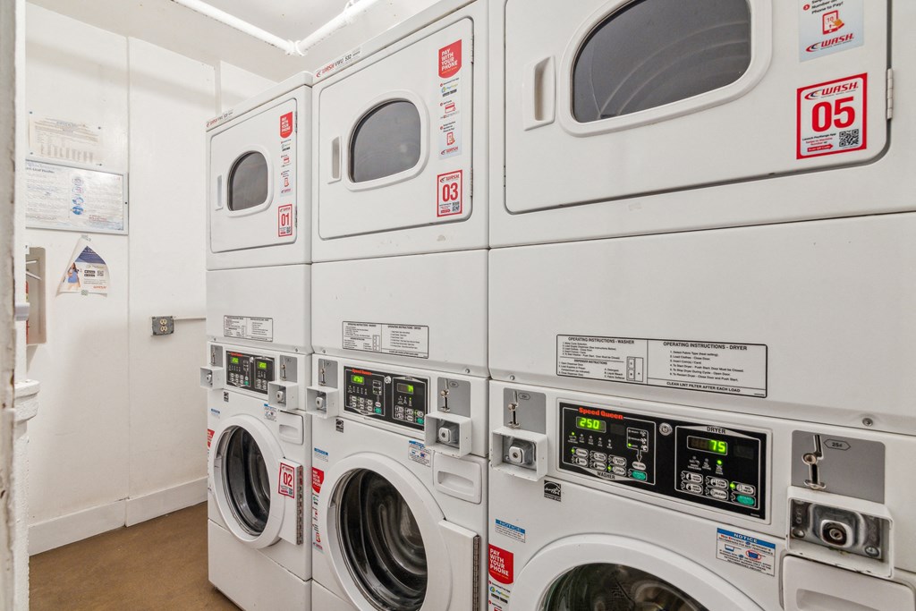 Laundry room with washing machines neatly arranged on a wooden floor