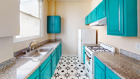 A kitchen with a white stove and a black and white floor.