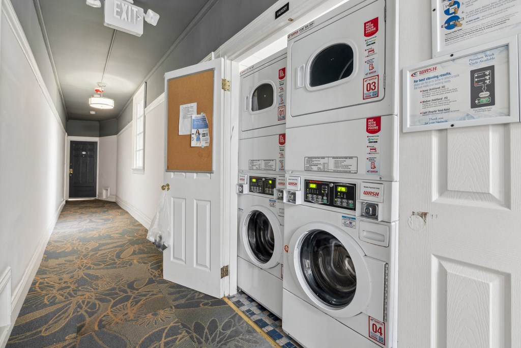 Laundry room with washing machines neatly arranged on a wooden floor