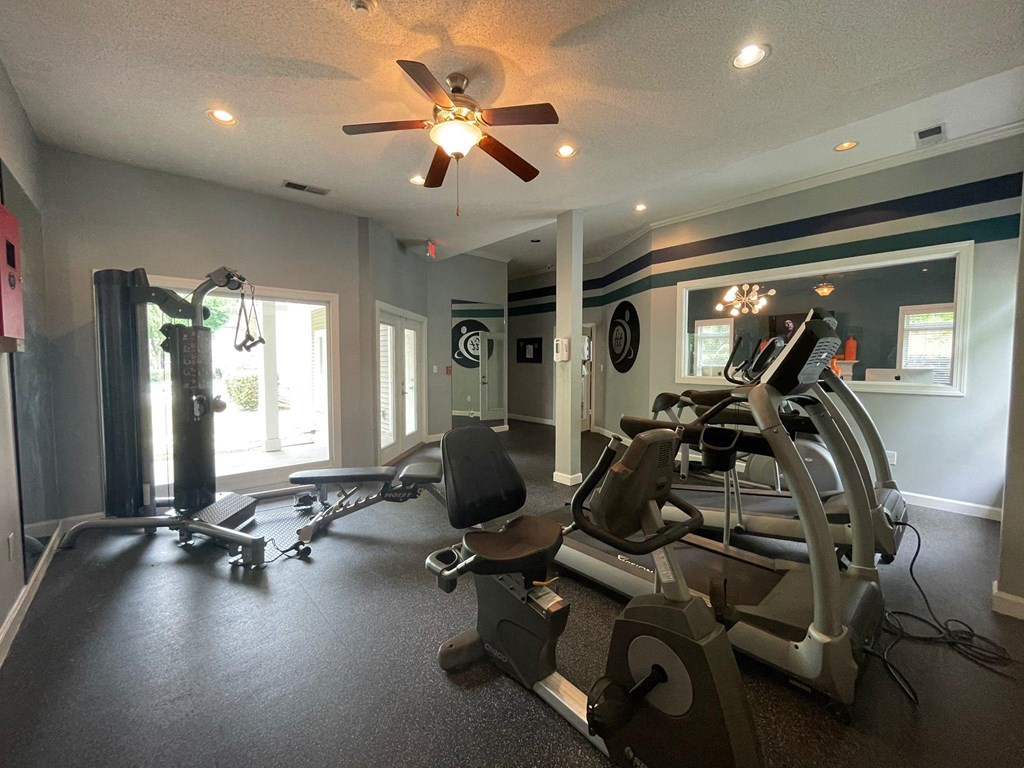 a home gym with machines and a ceiling fan at Hidden Creek, Morrow, Georgia