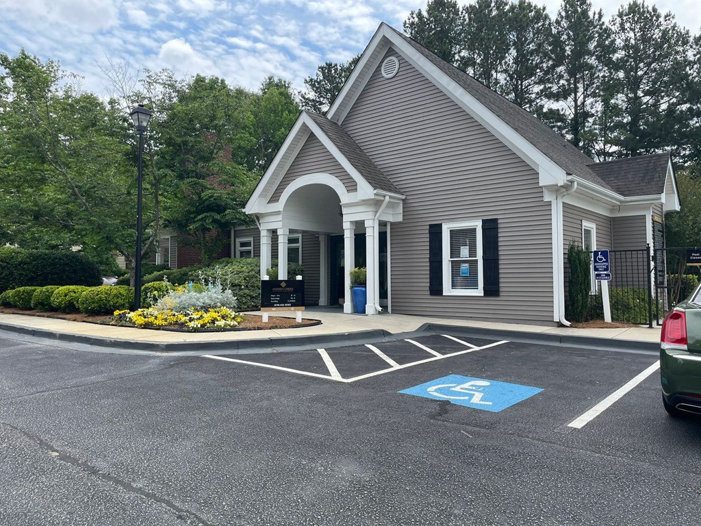 a parking lot in front of a gray building with a driveway at Hidden Creek, Morrow, Georgia 30260