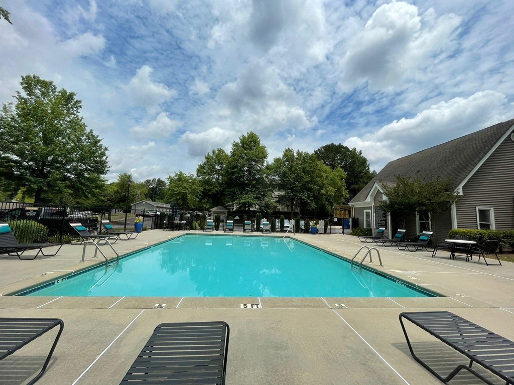 the swimming pool at the resort style clubhouse with chairs around it at Hidden Creek, Georgia 30260