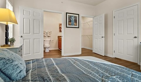 Master bedroom with ensuite bathroom and walk-in closet at Ansley Place Apartments, Houma, Louisiana