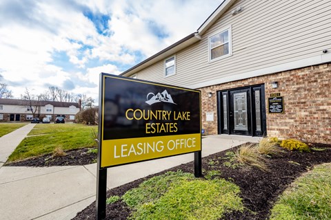 Leasing office entrance with property sign at Country Lake Estates Apartments, Indianapolis, IN