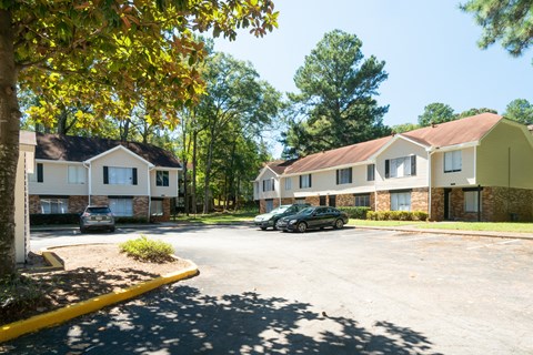 a parking lot in front of a row of houses