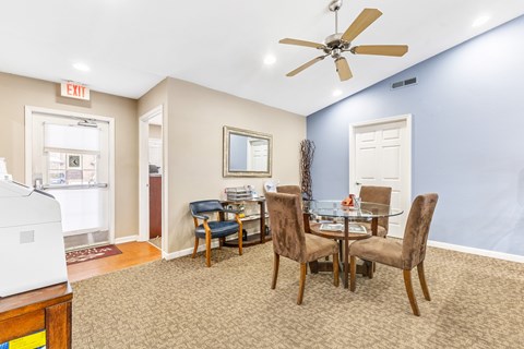 Dining area with glass table and brown chairs at Northampton Village Apartments, Indianapolis, 46226