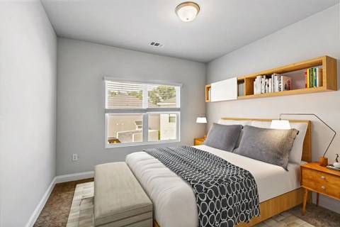 A bedroom with a large bed and a window overlooking a balcony.