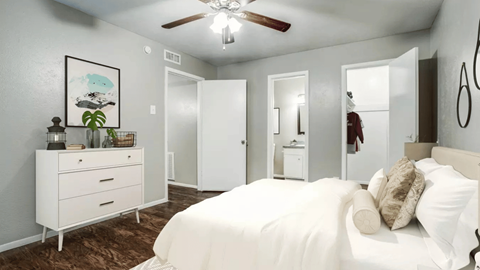 A bedroom with a bed, dresser, and mirror.