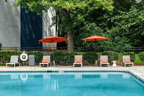 a swimming pool with chairs and umbrellas next to a resort pool at Glen Hollow, Georgia 30034