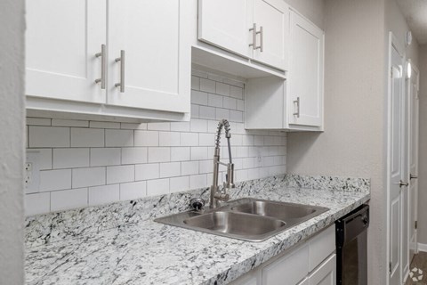 a kitchen with a sink and white cabinetsat Glen Hollow,Decatur, GA, 30034