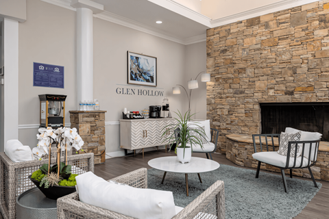 a living room with a stone fireplace and a coffee table at Glen Hollow, Georgia